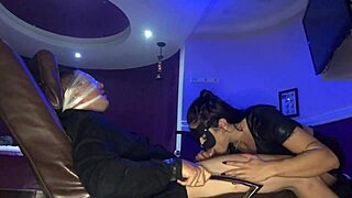 in the shadows, the dominatrix starts her secret blowjob with the submissive brunette