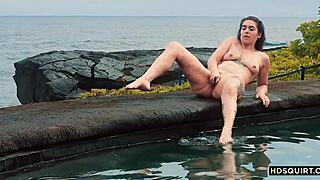 watch this free spirit girl squirt by the shore