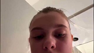 In the public changing room, she fingers her tight pussy eagerly.