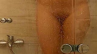 In the steamy bath, a voluptuous milf tenderly caresses her ample tits and juicy pussy.