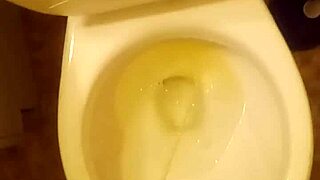 21 year old taking a piss in the toilet with a bit of penis showing