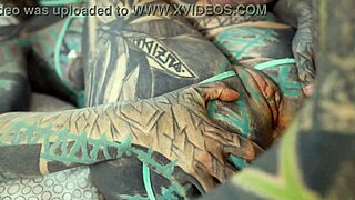 heavily tattooed girl engages in intense bedroom exercises with a partner