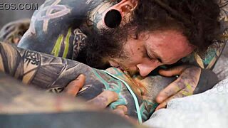 heavily tattooed girl engages in intense bedroom exercises with a partner