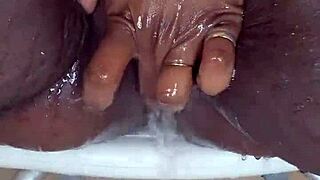 black milf meticulously shaves her wet ebony pussy on camera