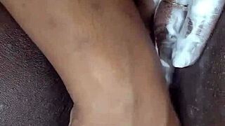 black milf meticulously shaves her wet ebony pussy on camera