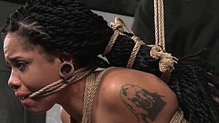 bound ebony endures garage domination torment