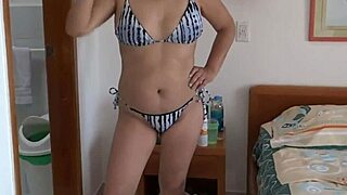 Bikini beauty fingers herself standing before deep pounding