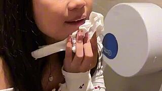 18-year-old asian cutie drops to knees for huge facial cumshot in public restroom blowjob
