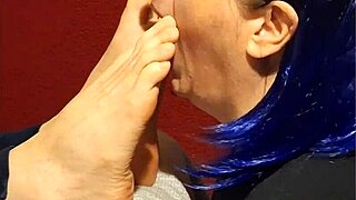 She kneels down eagerly wrapping lips around each of my toes sucking passionately with foot fetish desire