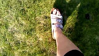 She slips off her flip-flops for a barefoot outdoor tease in the fields