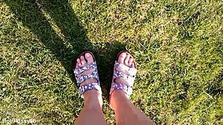 She slips off her flip-flops for a barefoot outdoor tease in the fields