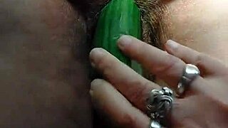 granny stuffs cucumber deep in her hairy wet pussy