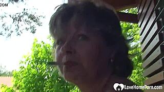 busty milf spreads shaved pussy wide in outdoor closeup