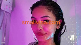 Petite Asian strips solo exposing wet pussy