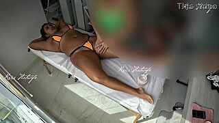 tanned beauty flashes big pussy during micro bikini massage