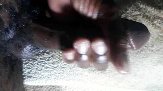 Huge cumshot from Kenyan big black cock handjob closeup