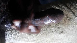 Huge cumshot from Kenyan big black cock handjob closeup