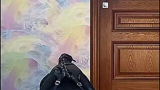 bound crossdresser locked in armbinder gag awaits intense bondage fate desperately