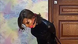 bound crossdresser locked in armbinder gag awaits intense bondage fate desperately