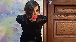 bound crossdresser locked in armbinder gag awaits intense bondage fate desperately