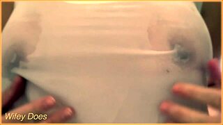 my wife's braless wet singlet reveals her stunning curves so teasingly