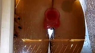 girl plays with toy in shower showing juicy ass