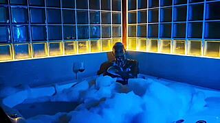 Tanned stud strokes huge cock in bubbly bath tub