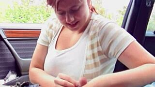 young redhead bbw girl poses playfully inside car