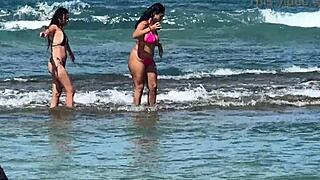 two pretty brunettes flaunt big asses on public beach