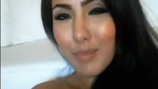 the camgirl grabs her dildo sucking it deep while masturbating
