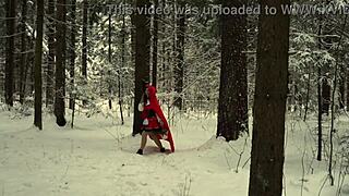 red hood tempts deep in snowy forest on christmas adventure
