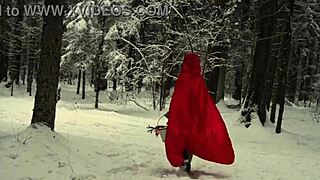 red hood tempts deep in snowy forest on christmas adventure