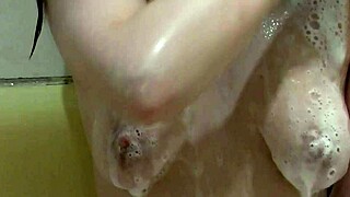 beautiful cute girl assol bathes in soapy foam on body