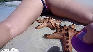 guy controls her remote vibrator while she walks nude on crowded beach