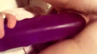 Wife stretches wet pussy deep with massive purple dildo for intense solo fuck