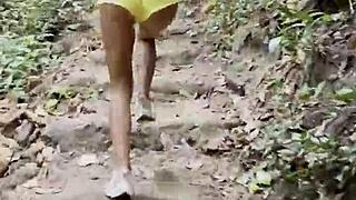 monika fox parades pink top yellow shorts through steamy jungle waterfalls