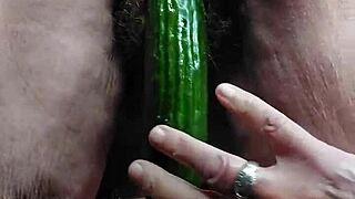 old horny slut fucks pussy with cucumber