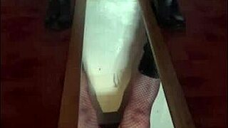 Bisexual crossdresser stands over mirror and releases