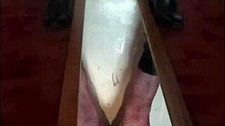 Bisexual crossdresser stands over mirror and releases