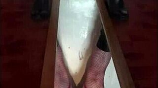 Bisexual crossdresser stands over mirror and releases